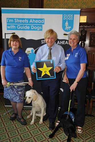 Michael holding the charity’s star on Guide Dogs