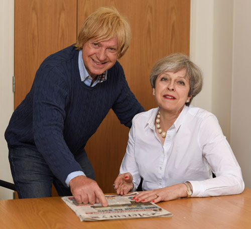 Michael with the Prime Minister looking at local newspaper